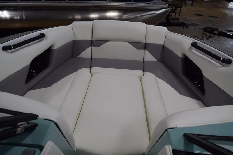 Slide: The Image of 2025 Moomba Mojo boat interior with white and gray seating, showcasing modern design. - 18