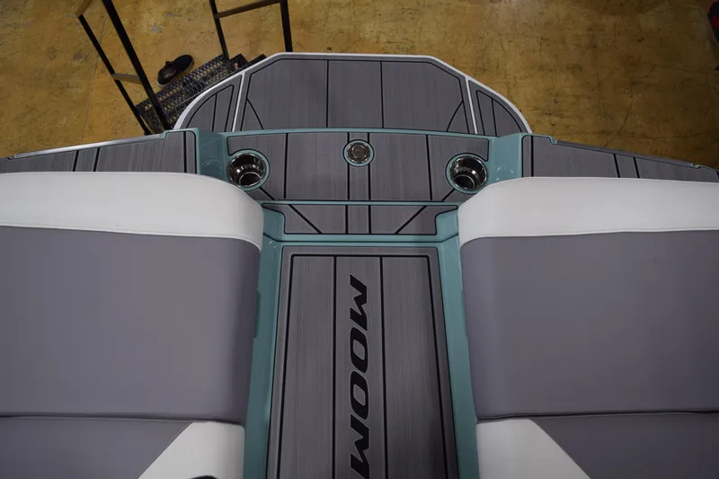 Slide: The Image of 2025 Moomba Mojo boat interior with gray and white seating, cup holders, and sleek design. - 26