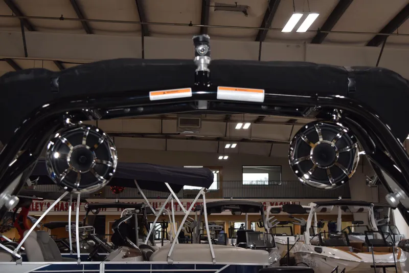 Slide: The Image of 2025 Moomba Mojo boat with speakers in a showroom setting. - 7