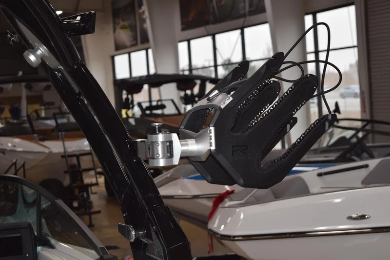 Slide: The Image of 2025 Moomba Mojo boat with advanced wakeboard rack in showroom. - 8