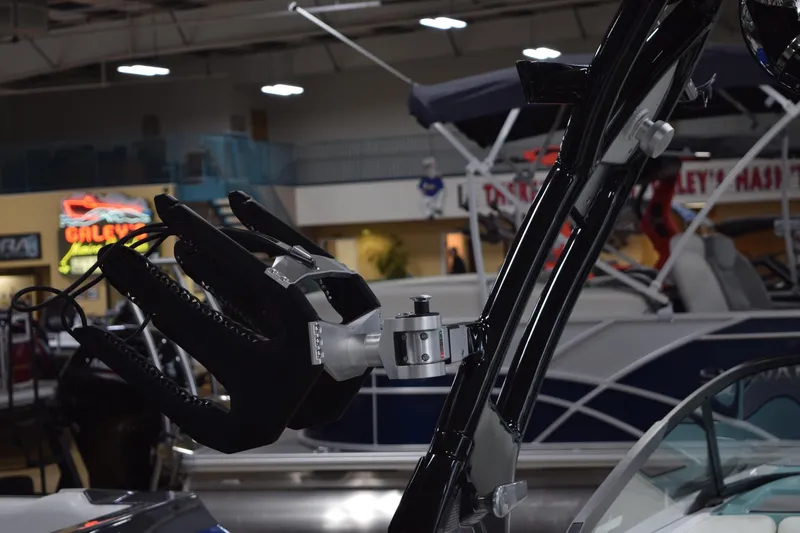 Slide: The Image of 2025 Moomba Mojo boat with advanced wakeboard tower in showroom setting. - 9