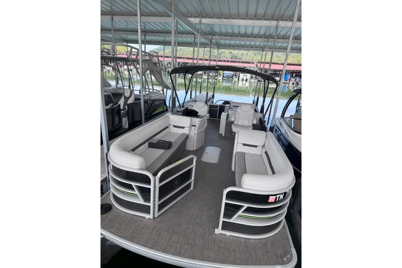 The Image of 2023 Godfrey SWEETWATER 2486 DT pontoon boat with spacious seating under covered dock. - 0