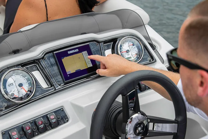 Slide: The Image of Manufacturer Provided Image: Man operating navigation system on 2023 Godfrey SWEETWATER 2486 DT boat. - 14