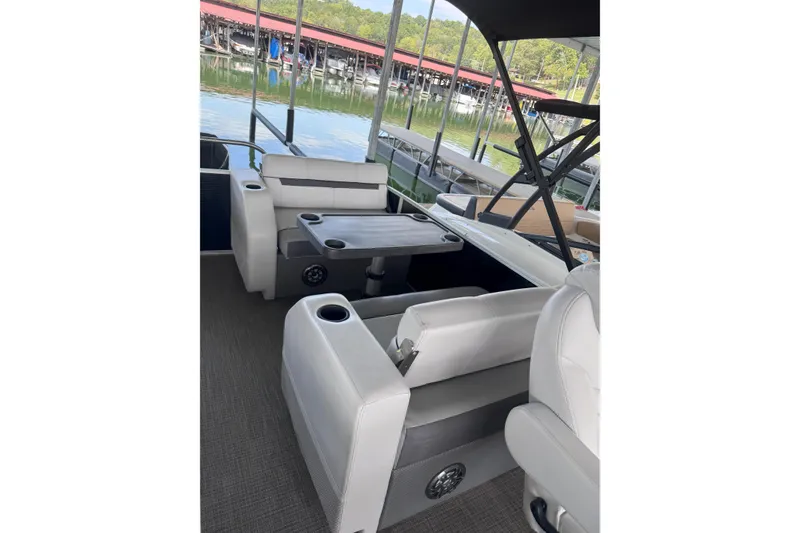 Slide: The Image of 2023 Godfrey SWEETWATER 2486 DT pontoon boat interior with seating and table. - 3