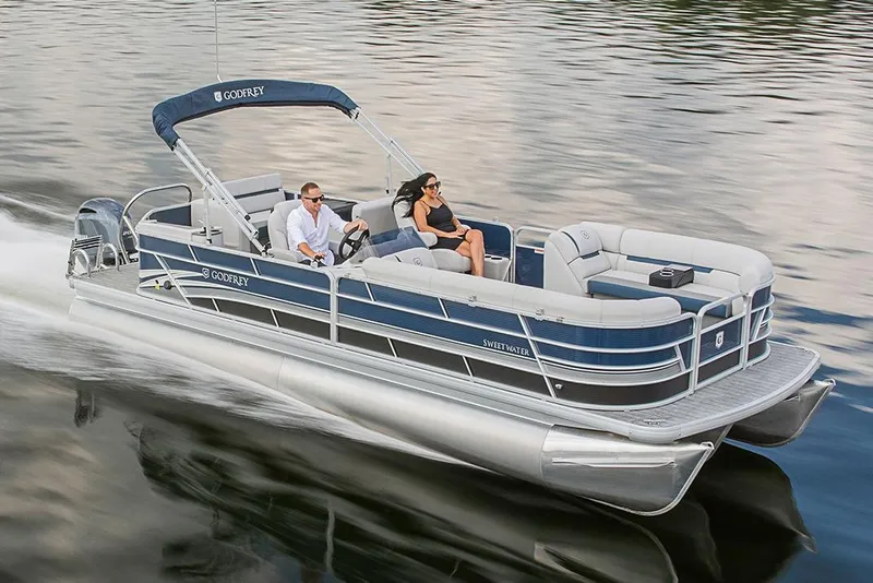 Slide: The Image of Manufacturer Provided Image: 2023 Godfrey SWEETWATER 2486 DT pontoon boat cruising on a lake. - 8