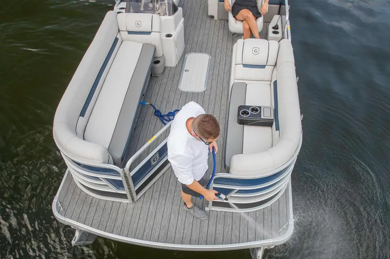 Slide: The Image of Manufacturer Provided Image: 2023 Godfrey SWEETWATER 2486 DT pontoon boat, man cleaning deck with hose. - 9