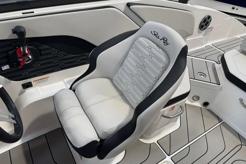 Slide: The Image of 2026 Sea Ray SPX 210 boat interior with sleek captain's chair and modern dashboard. - 34