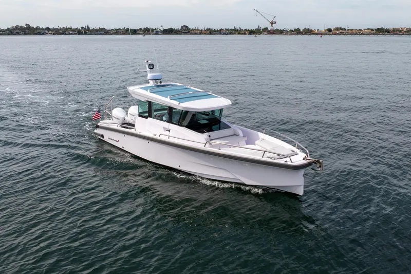 Slide: The Image of 2026 Axopar 29 XC Cross Cabin cruising on calm waters. - 18