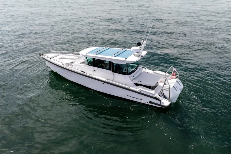 Slide: The Image of 2026 Axopar 29 XC Cross Cabin boat cruising on open water. - 19