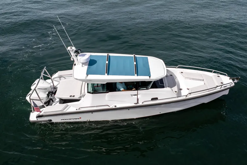 Slide: The Image of 2026 Axopar 29 XC Cross Cabin boat cruising on open water. - 21