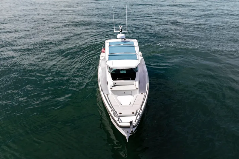 Slide: The Image of 2026 Axopar 29 XC Cross Cabin boat on open water, aerial view. - 22