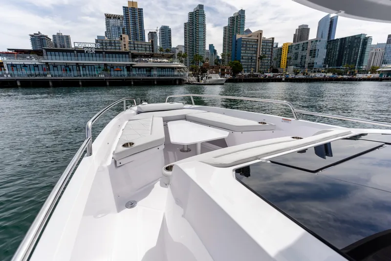 Slide: The Image of 2026 Axopar 29 XC Cross Cabin boat with city skyline in the background. - 29