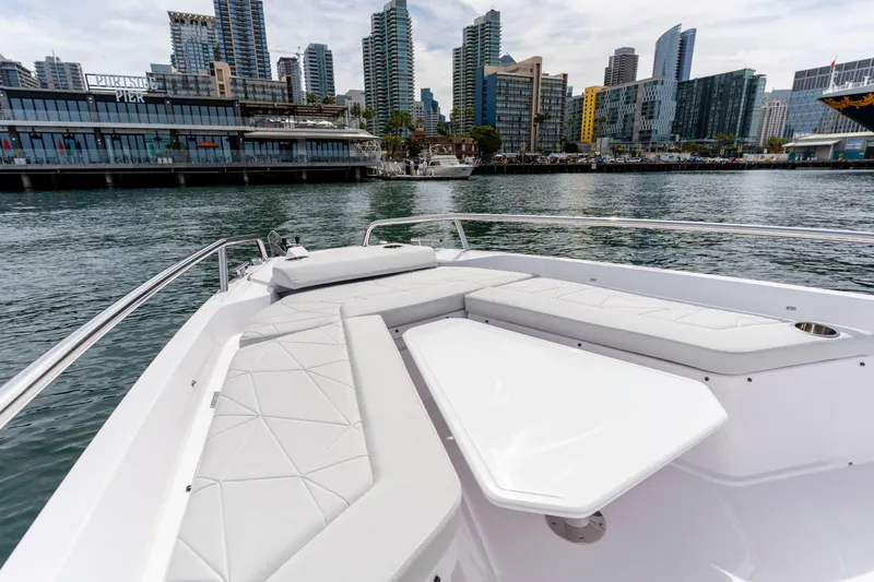 Slide: The Image of 2026 Axopar 29 XC Cross Cabin boat with city skyline in background. - 30
