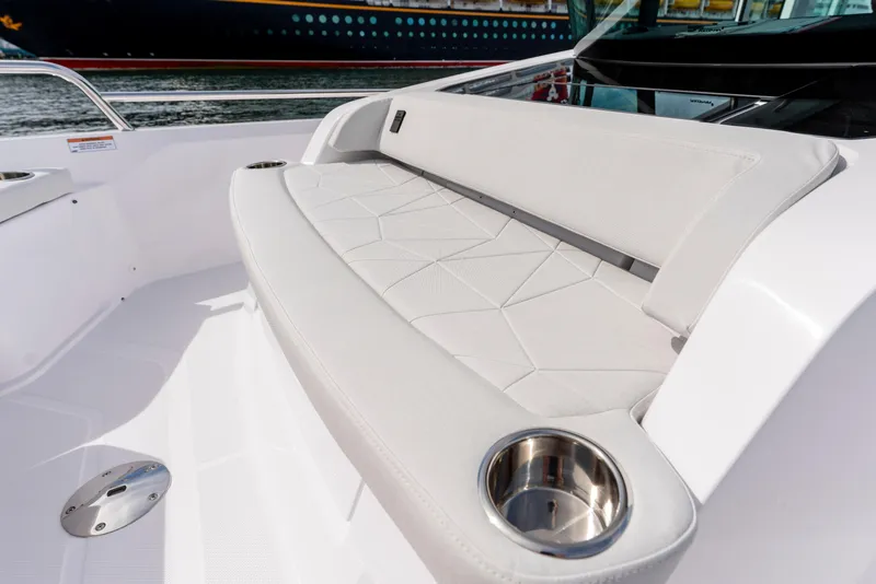 Slide: The Image of 2026 Axopar 29 XC Cross Cabin boat interior with cushioned seating and cup holders. - 31