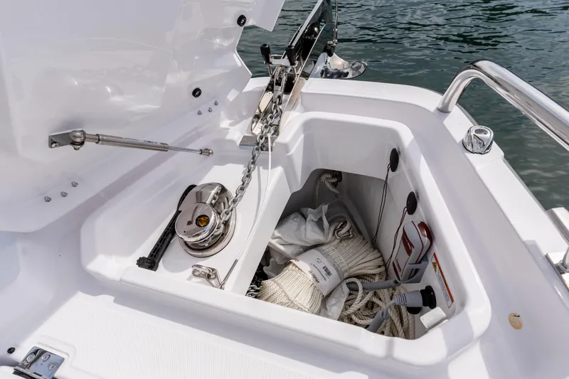 Slide: The Image of Anchor compartment of 2026 Axopar 29 XC Cross Cabin with ropes and equipment. - 33