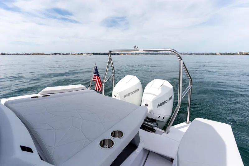 Slide: The Image of 2026 Axopar 29 XC Cross Cabin boat with twin Mercury engines on calm water. - 41