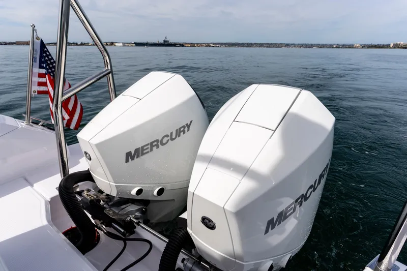 Slide: The Image of Twin Mercury outboard engines on 2026 Axopar 29 XC Cross Cabin boat, American flag visible. - 42