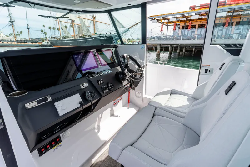 Slide: The Image of Interior of 2026 Axopar 29 XC Cross Cabin with modern dashboard and seating. - 44