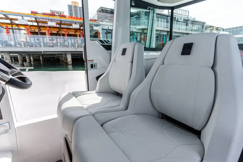 Slide: The Image of Interior of 2026 Axopar 29 XC Cross Cabin with modern seating and waterfront view. - 45