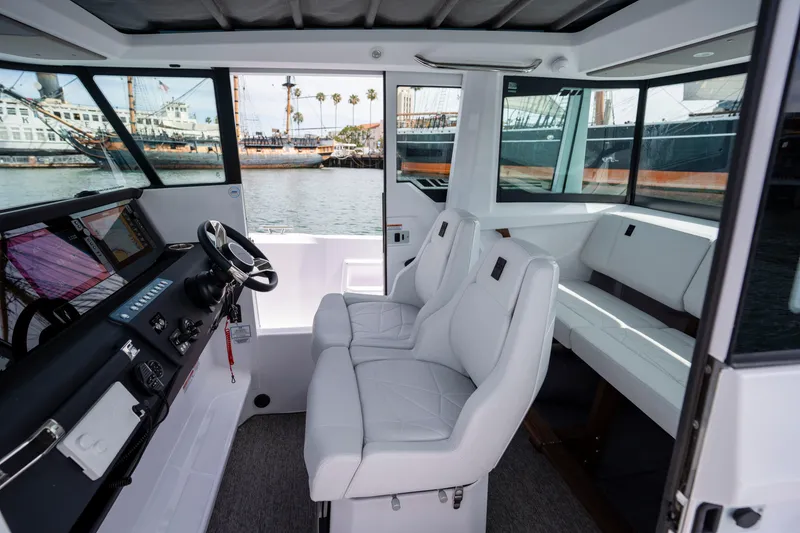 Slide: The Image of 2026 Axopar 29 XC Cross Cabin interior with modern seating and navigation controls. - 47