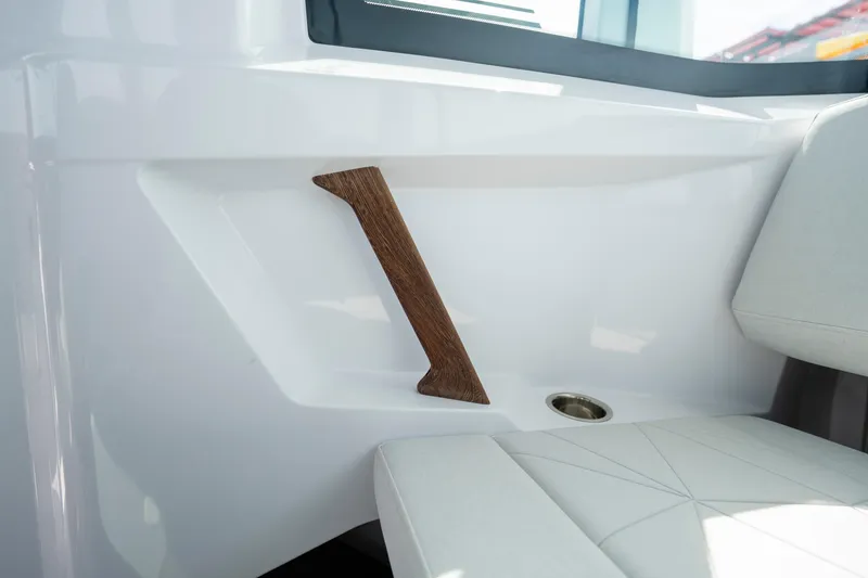 Slide: The Image of Interior detail of 2026 Axopar 29 XC Cross Cabin with wooden handle and white seating. - 54