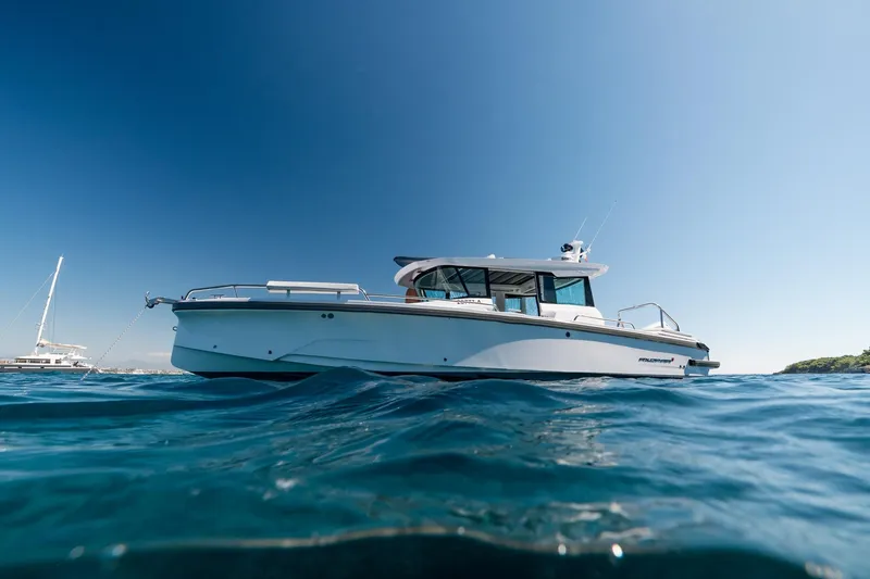 Slide: The Image of 2026 Axopar 29 XC boat on clear blue water under sunny sky. - 8