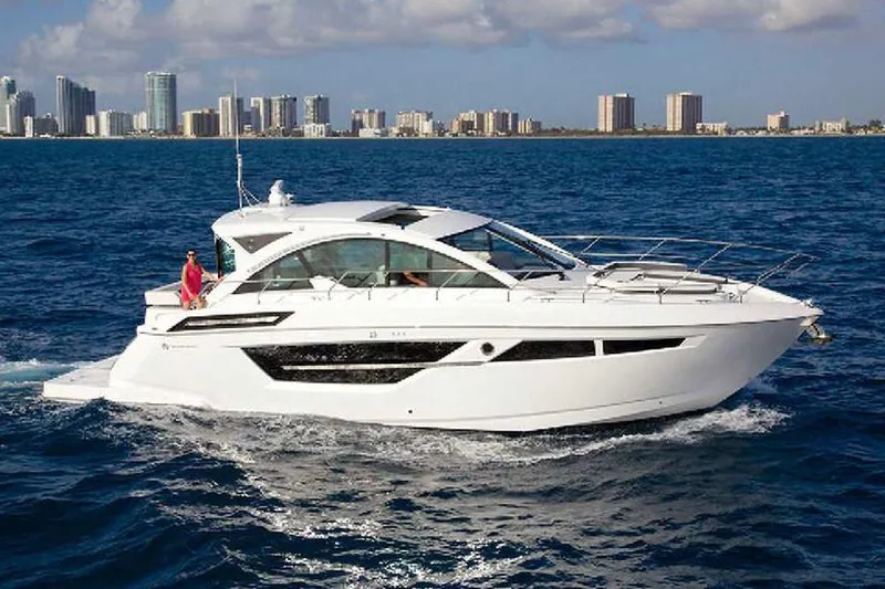 The Image of Manufacturer Provided Image: 2021 Cruisers Yachts 50 Cantius sailing near city skyline on blue ocean. - 0