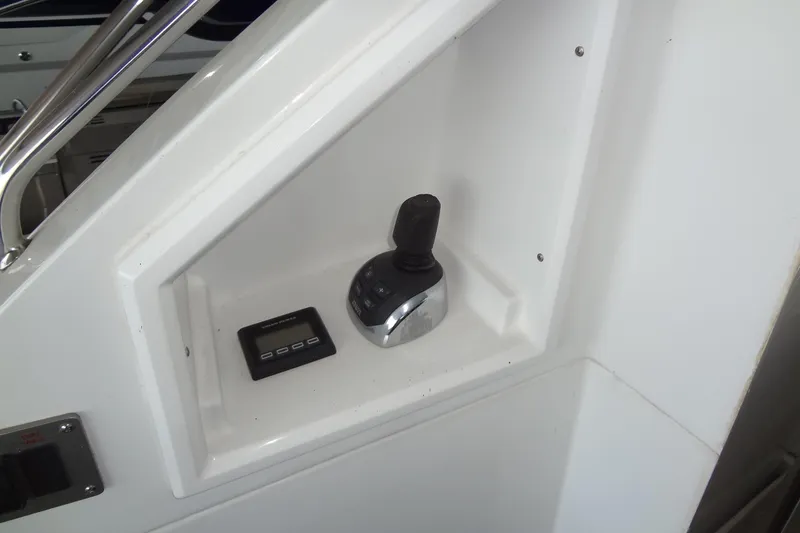 Slide: The Image of Control panel of 2021 Cruisers Yachts 50 Cantius, featuring joystick and display. - 10