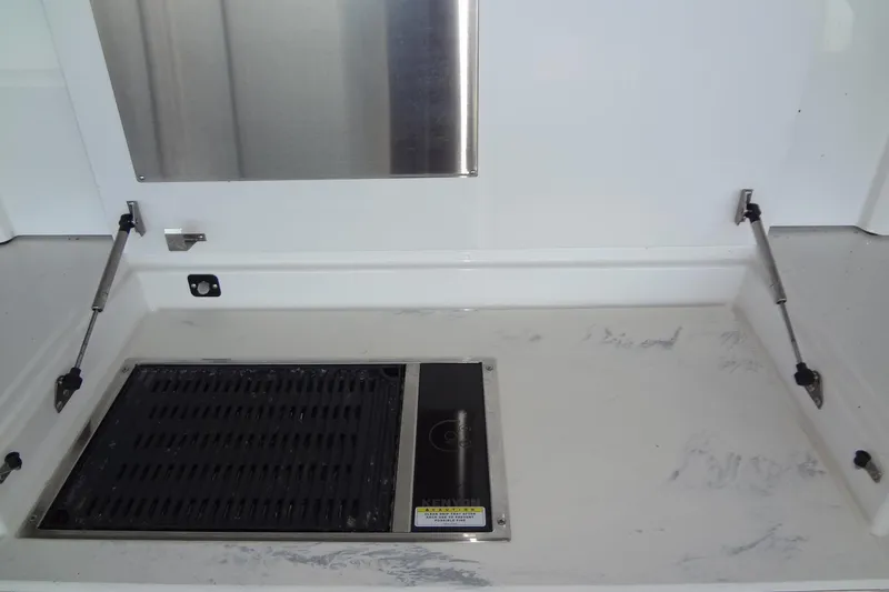 Slide: The Image of Outdoor grill area on 2021 Cruisers Yachts 50 Cantius, featuring stainless steel and marble surfaces. - 12