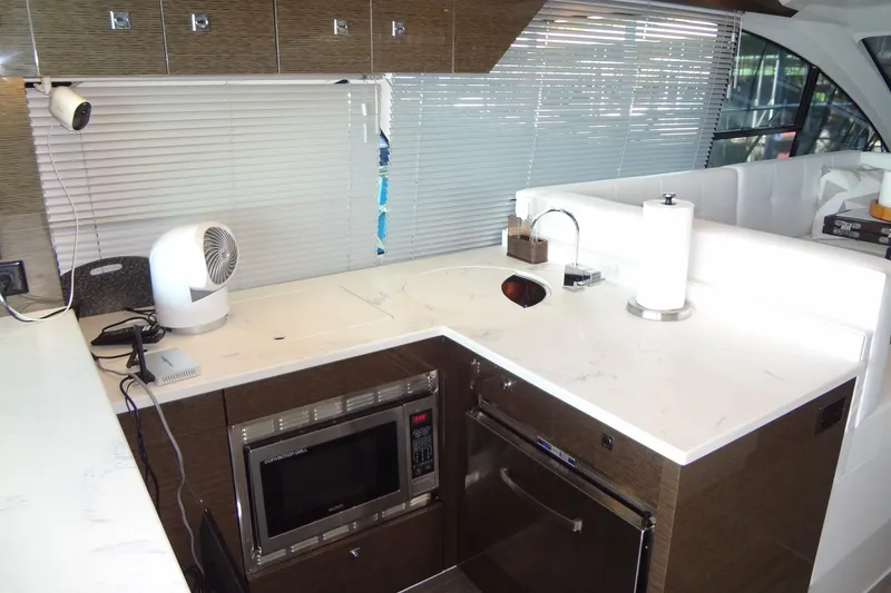 Slide: The Image of Modern kitchen area in 2021 Cruisers Yachts 50 Cantius with sleek countertops and appliances. - 14