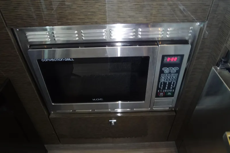 Slide: The Image of Convection grill microwave in 2021 Cruisers Yachts 50 Cantius kitchen area. - 16