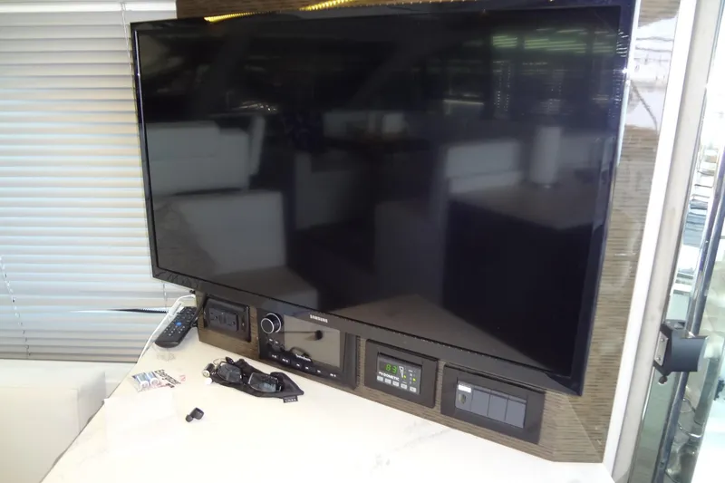 Slide: The Image of Samsung TV and control panel inside 2021 Cruisers Yachts 50 Cantius. - 19