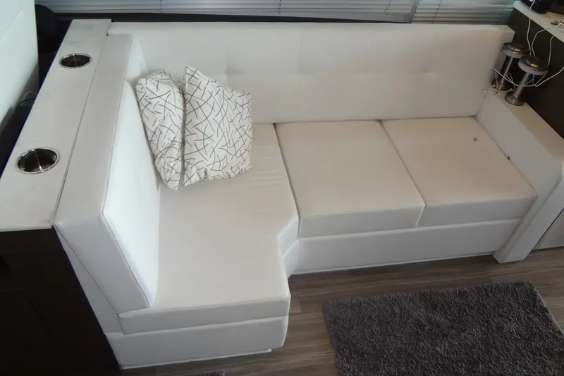 Slide: The Image of Luxurious white seating area on 2021 Cruisers Yachts 50 Cantius with decorative pillows. - 21