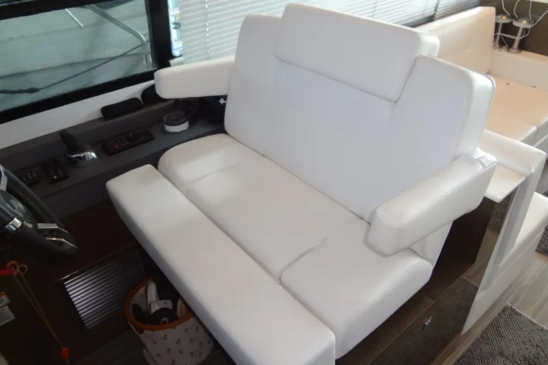 Slide: The Image of Luxurious white seating in 2021 Cruisers Yachts 50 Cantius cockpit area. - 26