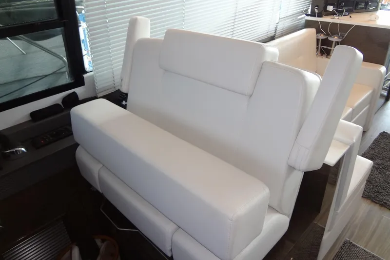 Slide: The Image of Luxurious white seating in 2021 Cruisers Yachts 50 Cantius interior. - 27