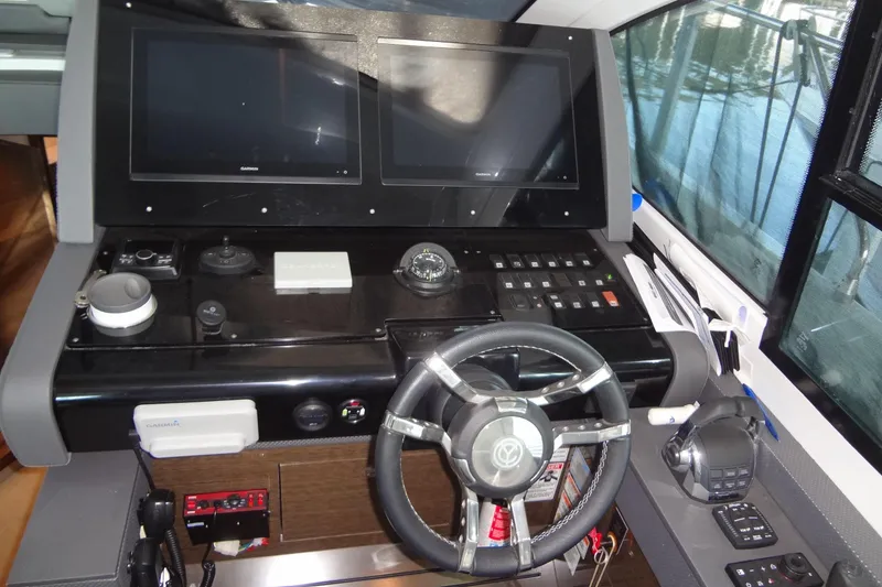 Slide: The Image of Helm of 2021 Cruisers Yachts 50 Cantius with dual screens and modern controls. - 29