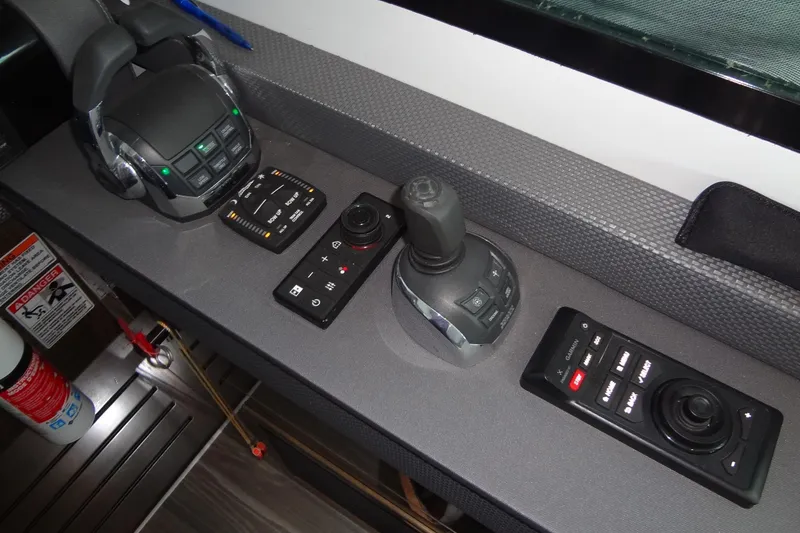 Slide: The Image of Control panel of 2021 Cruisers Yachts 50 Cantius with joystick and throttle controls. - 33
