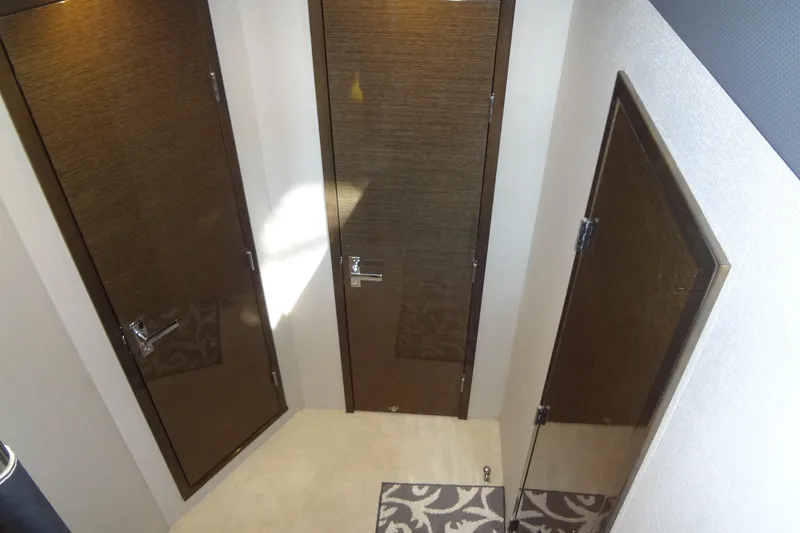 Slide: The Image of Interior view of 2021 Cruisers Yachts 50 Cantius with three wooden doors. - 36