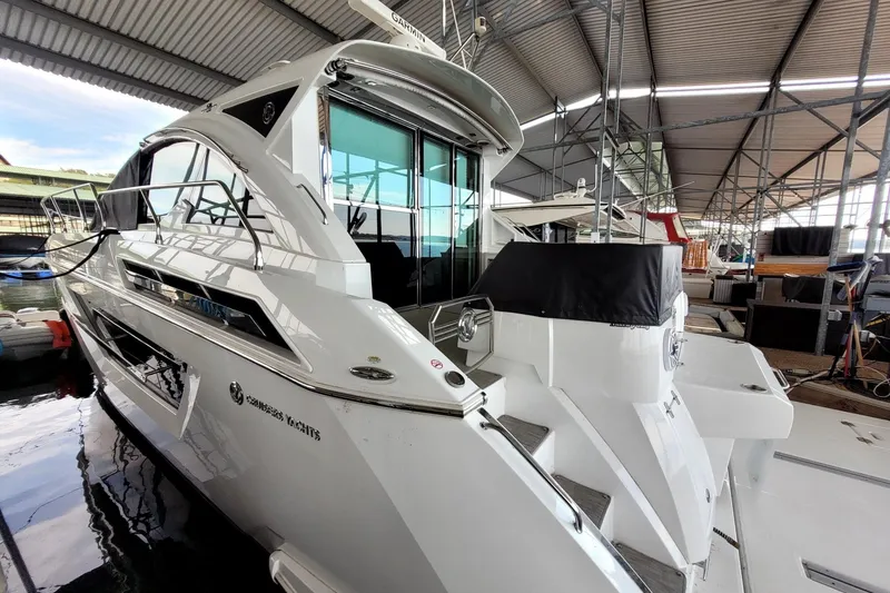 Slide: The Image of 2021 Cruisers Yachts 50 Cantius docked in a covered marina. - 4