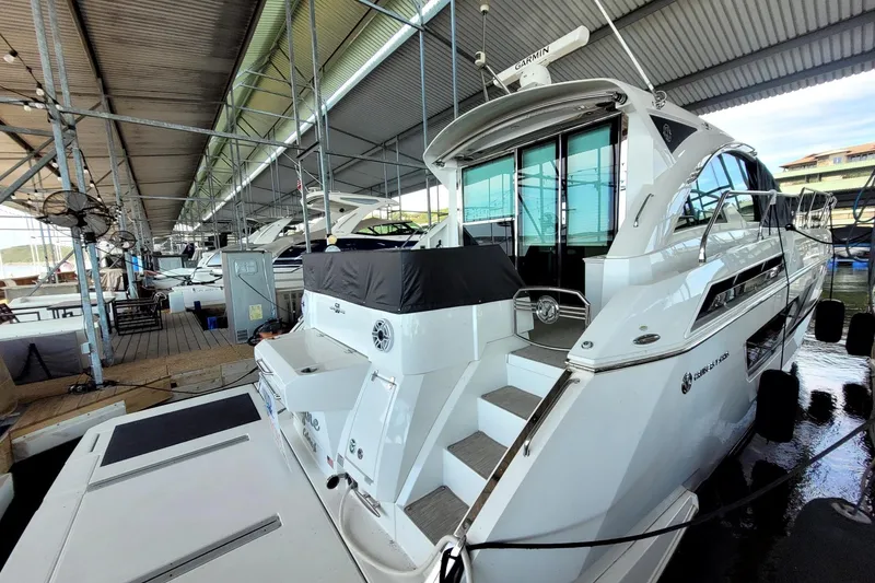 Slide: The Image of 2021 Cruisers Yachts 50 Cantius docked in a covered marina. - 5