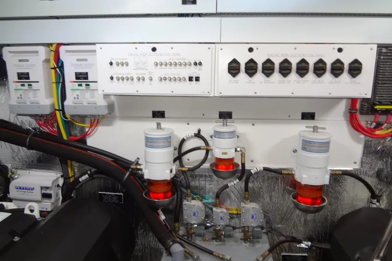 Slide: The Image of Engine room of 2021 Cruisers Yachts 50 Cantius with electrical panels and filters. - 60