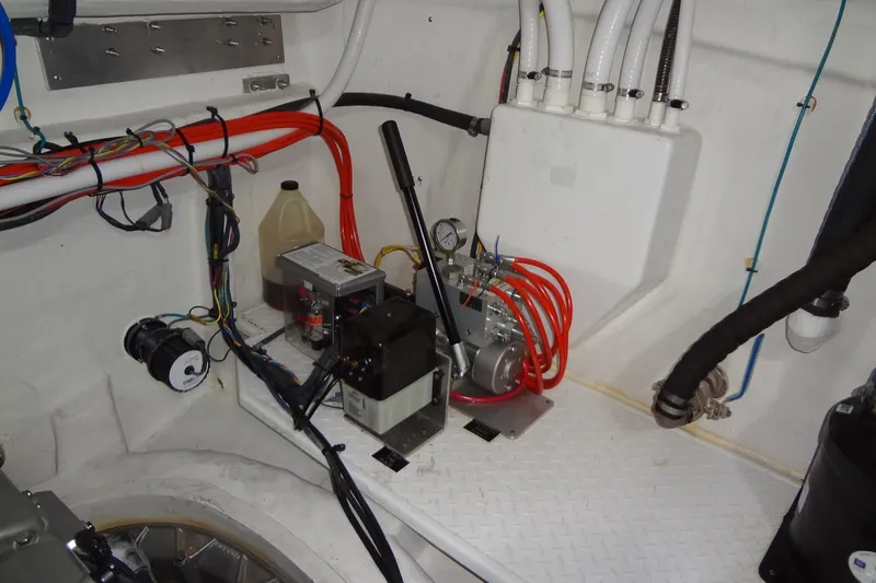 Slide: The Image of Engine room of 2021 Cruisers Yachts 50 Cantius with wiring and mechanical components. - 62