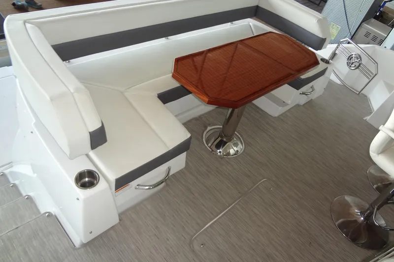 Slide: The Image of 2021 Cruisers Yachts 50 Cantius interior with white seating and wooden table. - 7