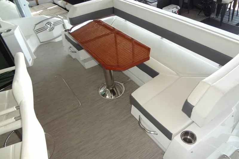 Slide: The Image of 2021 Cruisers Yachts 50 Cantius interior with elegant seating and wooden table. - 8