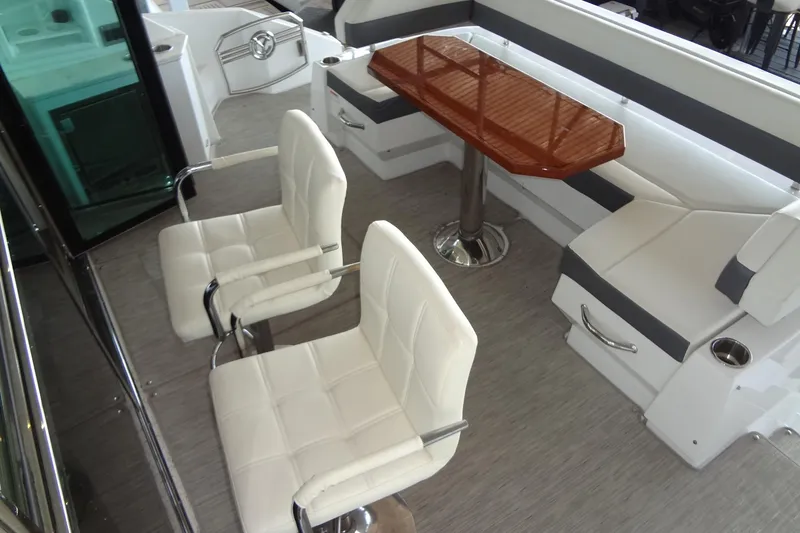 Slide: The Image of 2021 Cruisers Yachts 50 Cantius interior with white seating and wooden table. - 9
