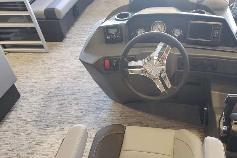Slide: The Image of 2026 Bennington 20SL boat interior with steering wheel and dashboard controls. - 16