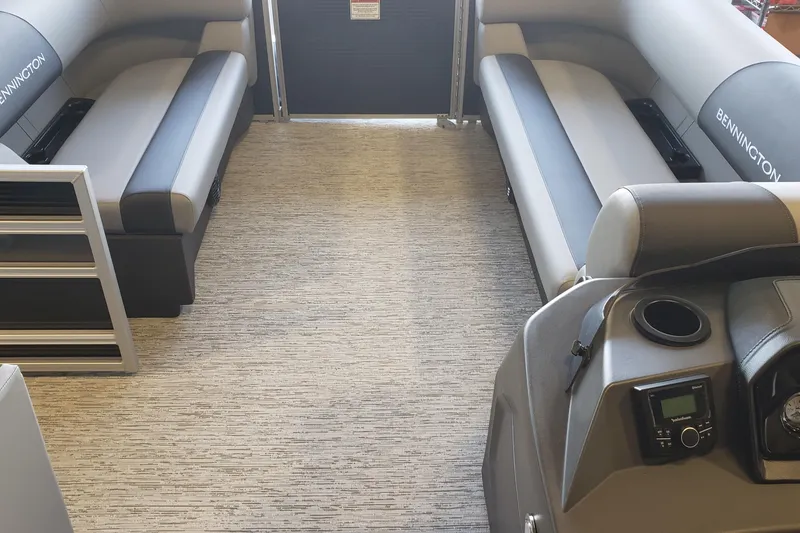 Slide: The Image of 2026 Bennington 20SL boat interior seating with gray upholstery and logo. - 8