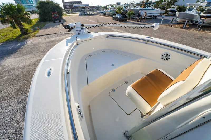 Slide: The Image of 2019 Bulls Bay 200 CC boat interior with seating and storage, parked outdoors. - 12