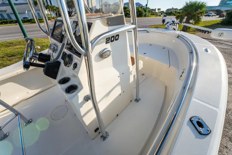 Slide: The Image of 2019 Bulls Bay 200 CC boat interior with steering console and seating area. - 14