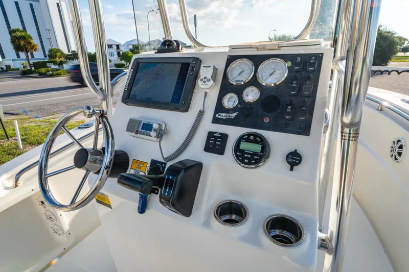Slide: The Image of 2019 Bulls Bay 200 CC boat dashboard with steering wheel and navigation instruments. - 16